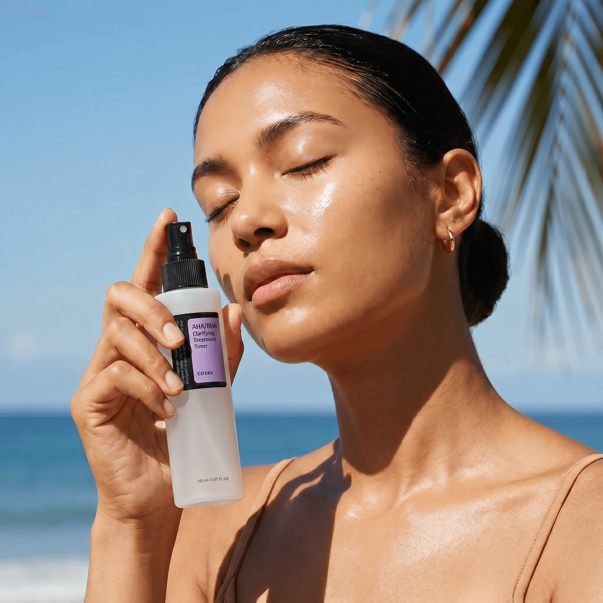 Model holding allbeauty haircare products