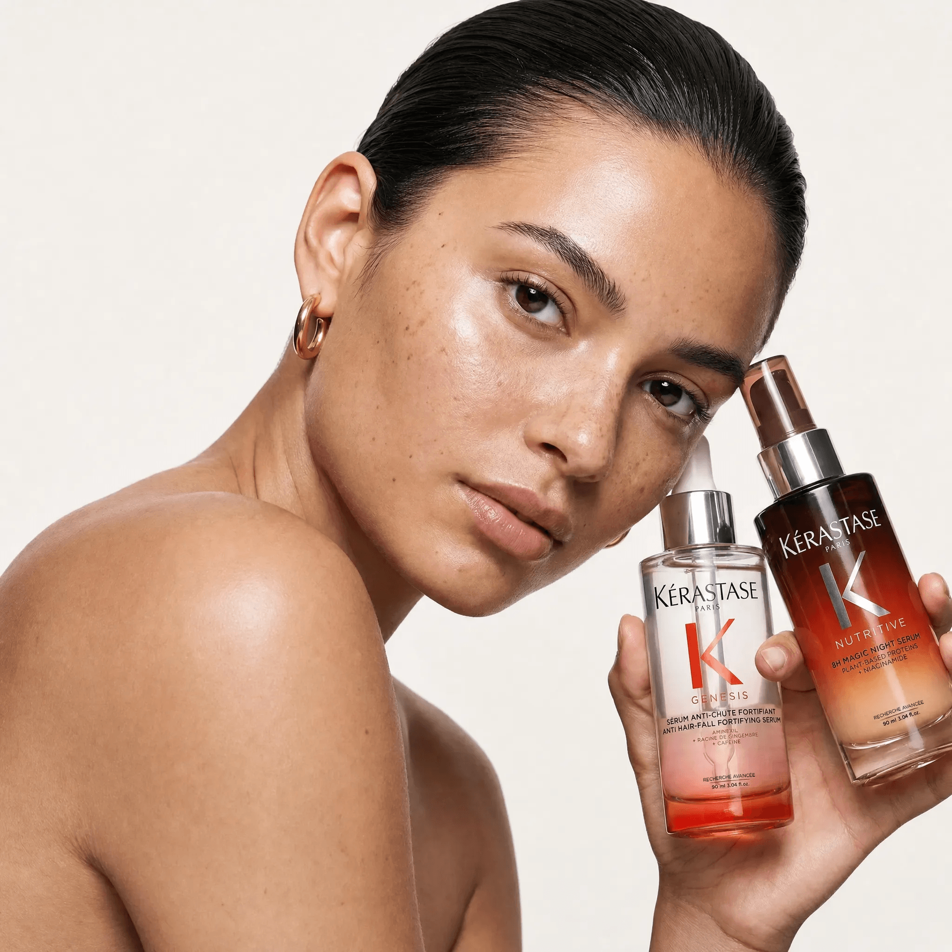Model holding Kérastase haircare products for allbeauty