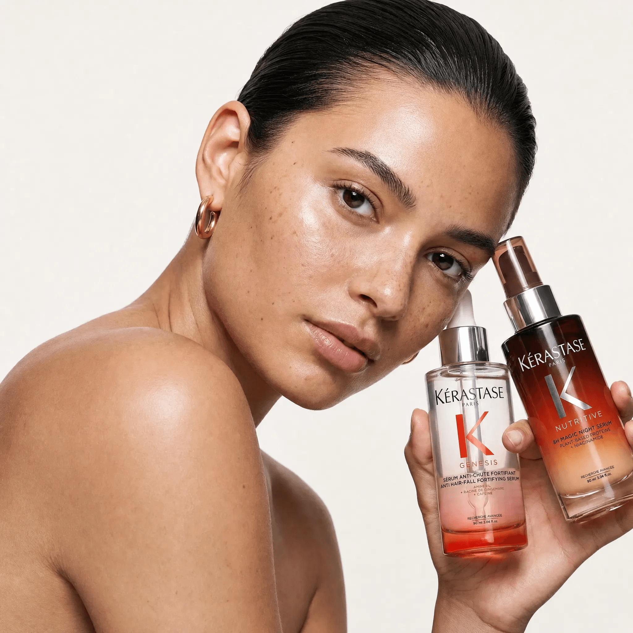 Model holding Kérastase haircare products for allbeauty