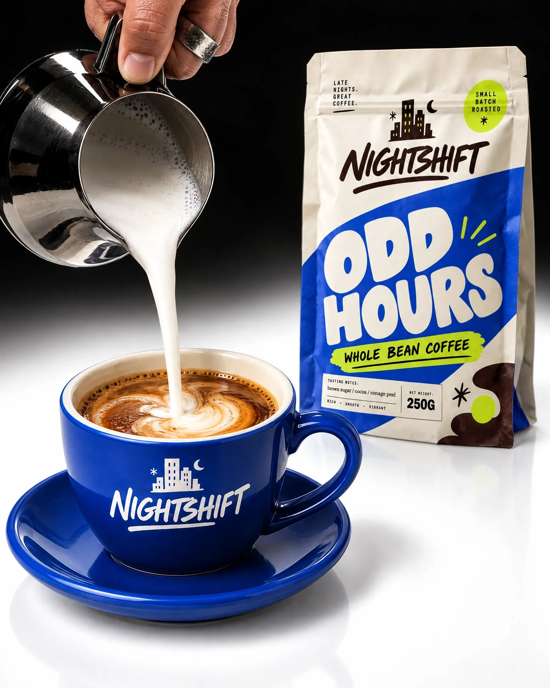 Milk pouring into a blue Nightshift coffee cup beside an Odd Hours pouch