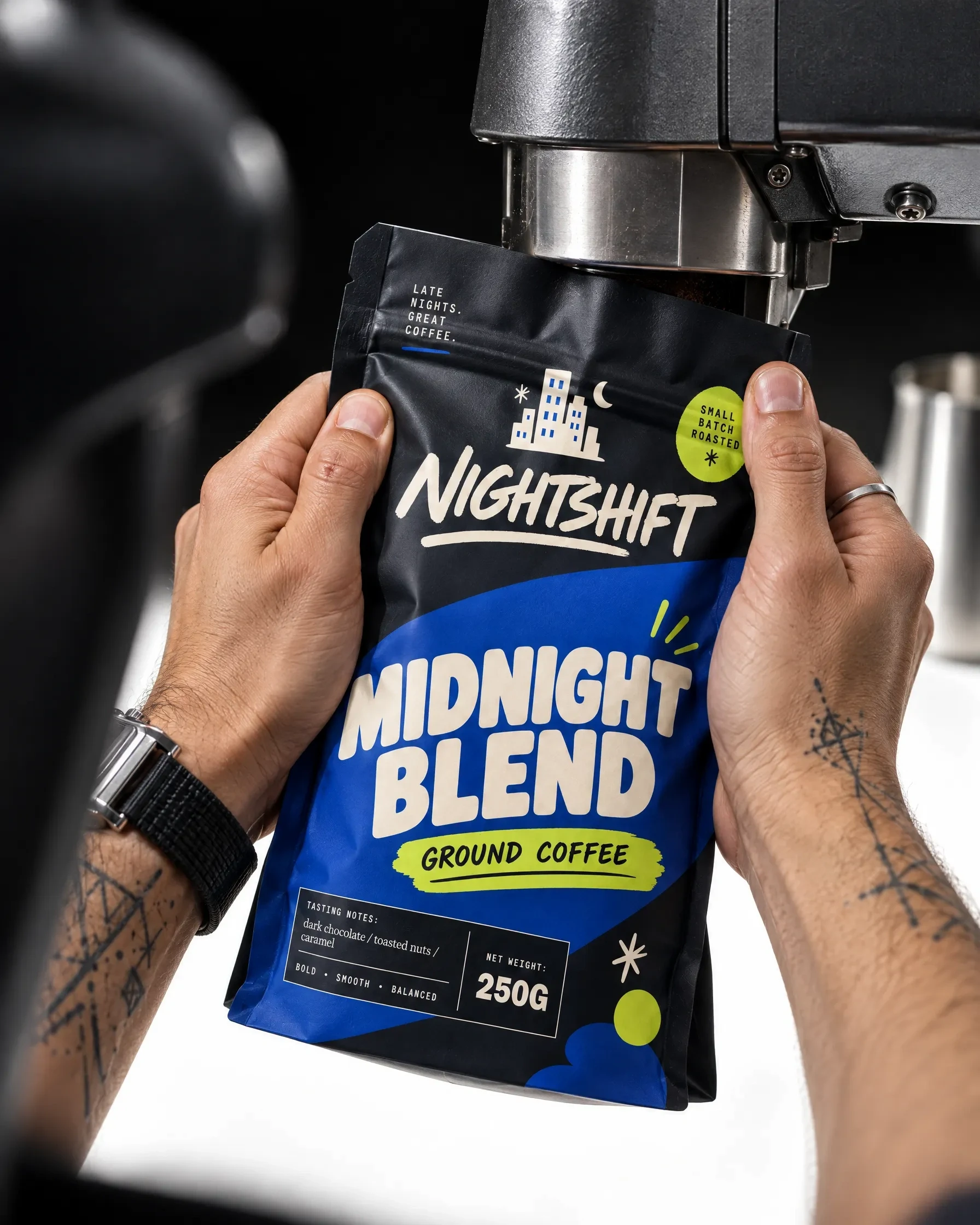 Nightshift Midnight Blend pouch held beside an espresso machine