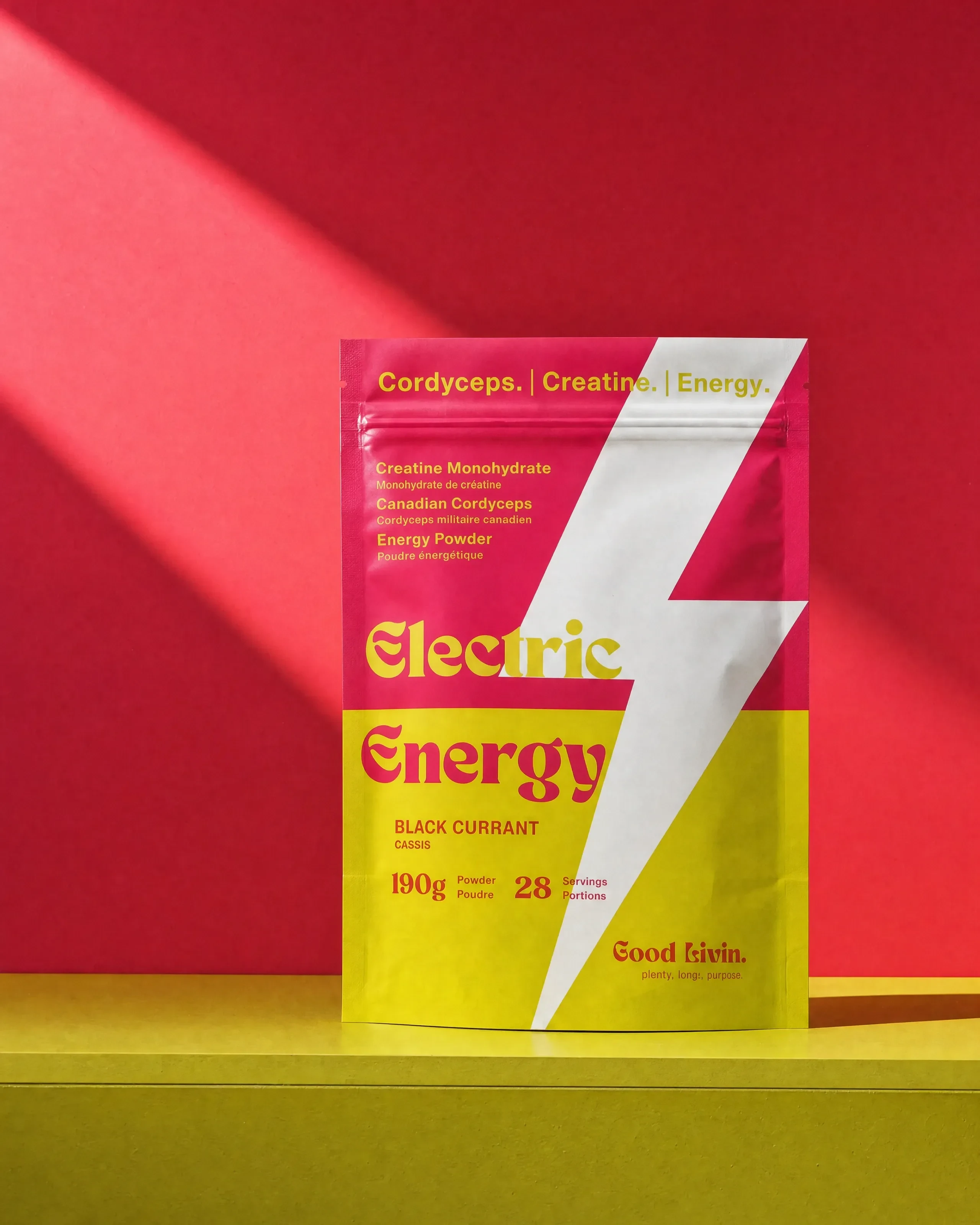 Good Livin' Electric Energy pouch against a pink and yellow background