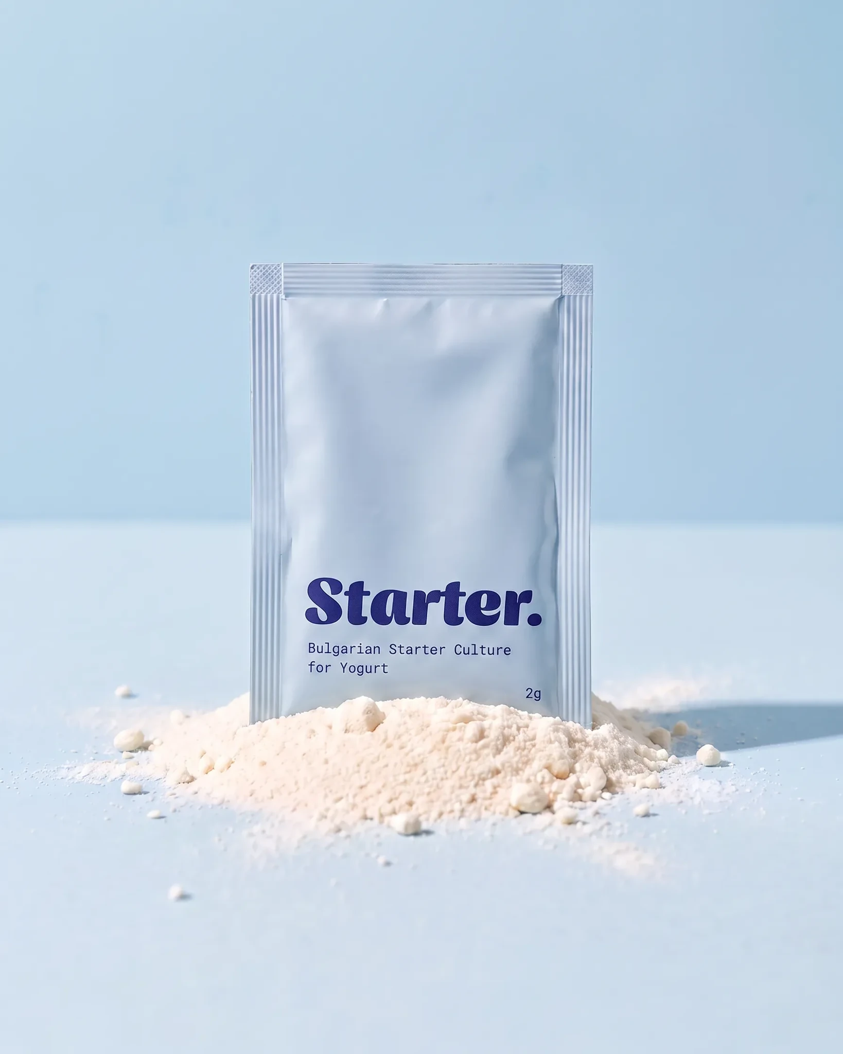 Starter Bulgarian yogurt culture pouch standing in powder against a pale blue background