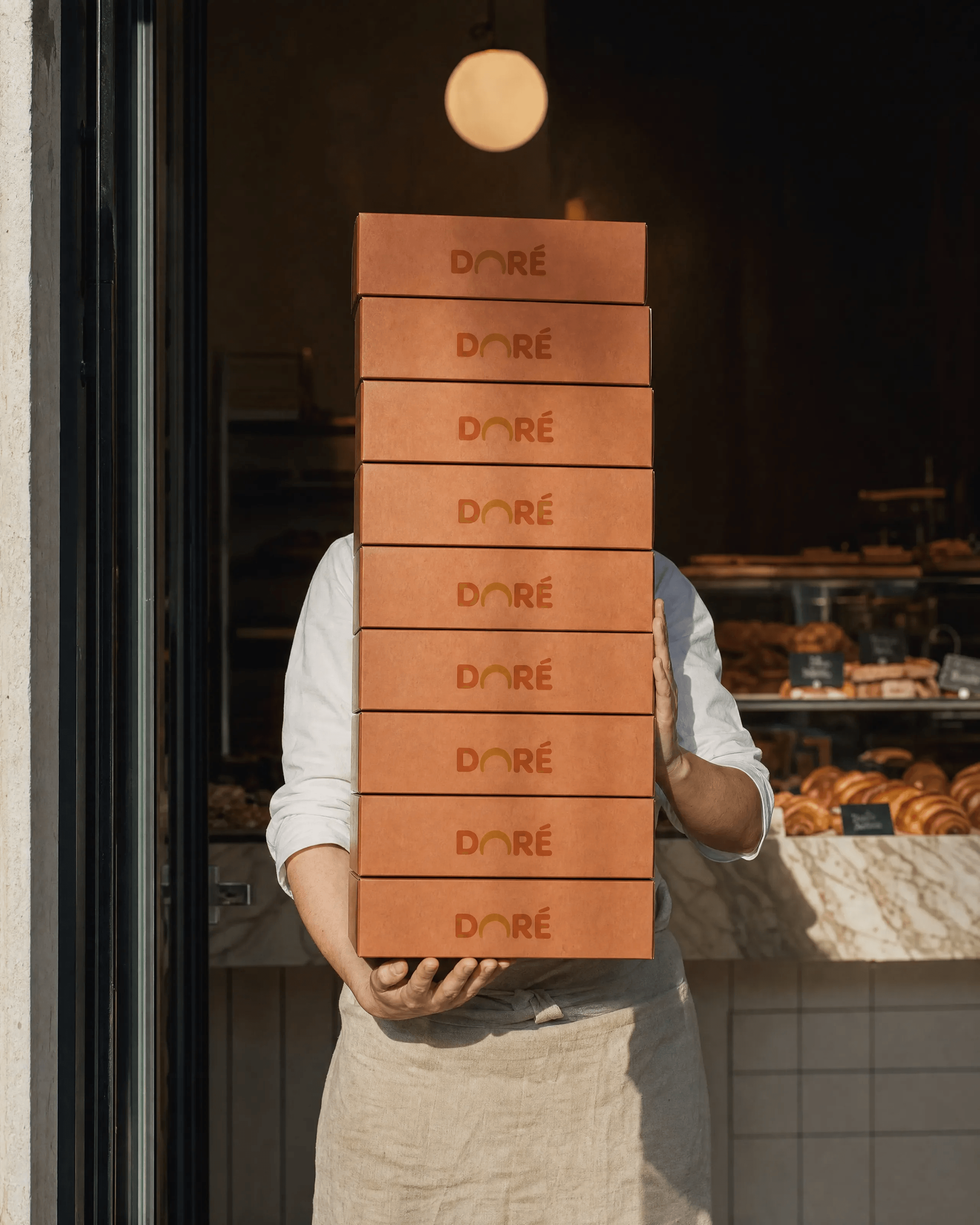 DORÉ: The Stack — A tower of takeaway boxes carried through the shop floor