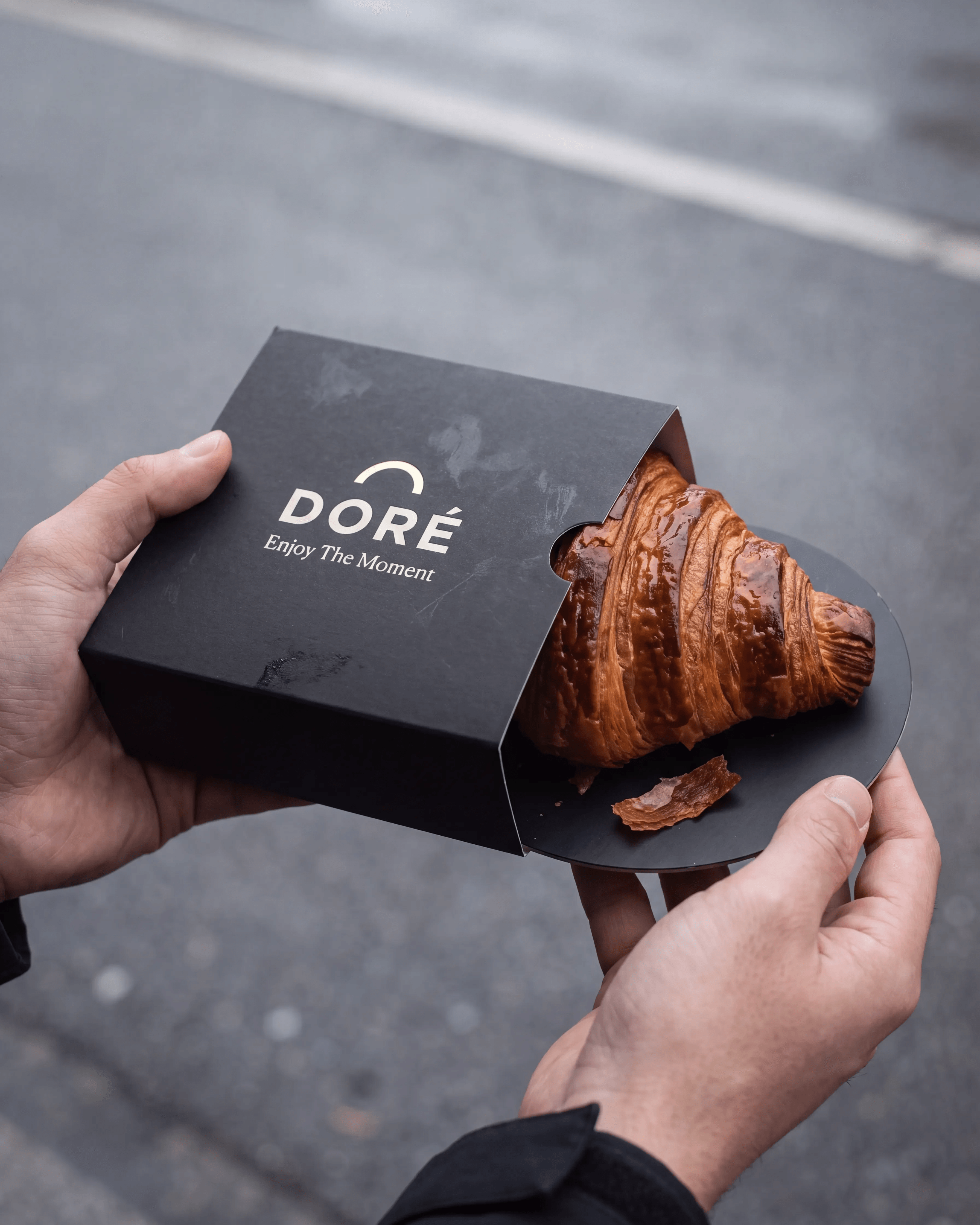 DORÉ: The Moment — Held mid-street, the sleeve half open