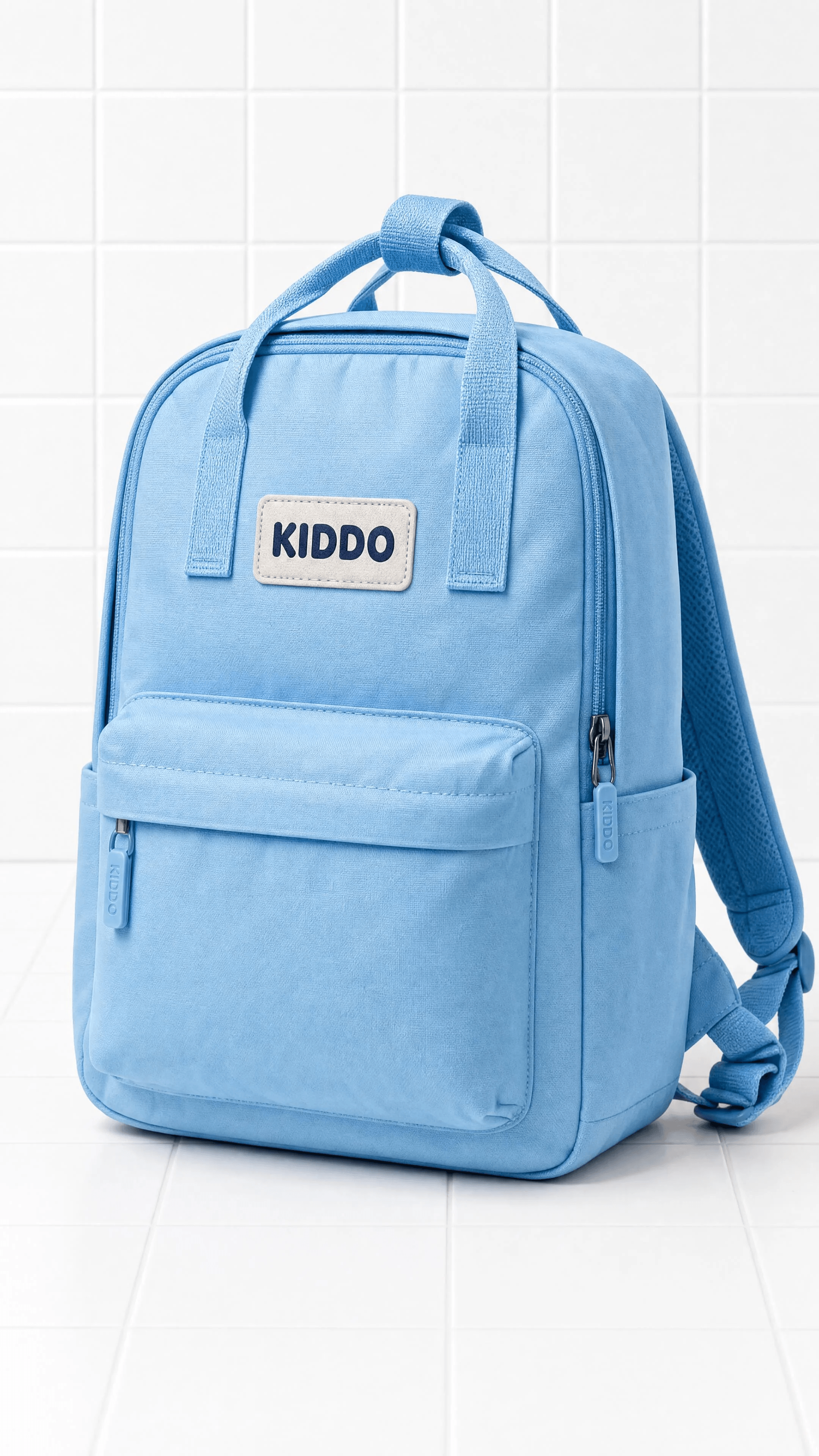 A sharp studio hero of the sky-blue KIDDO backpack against fine white tiles.