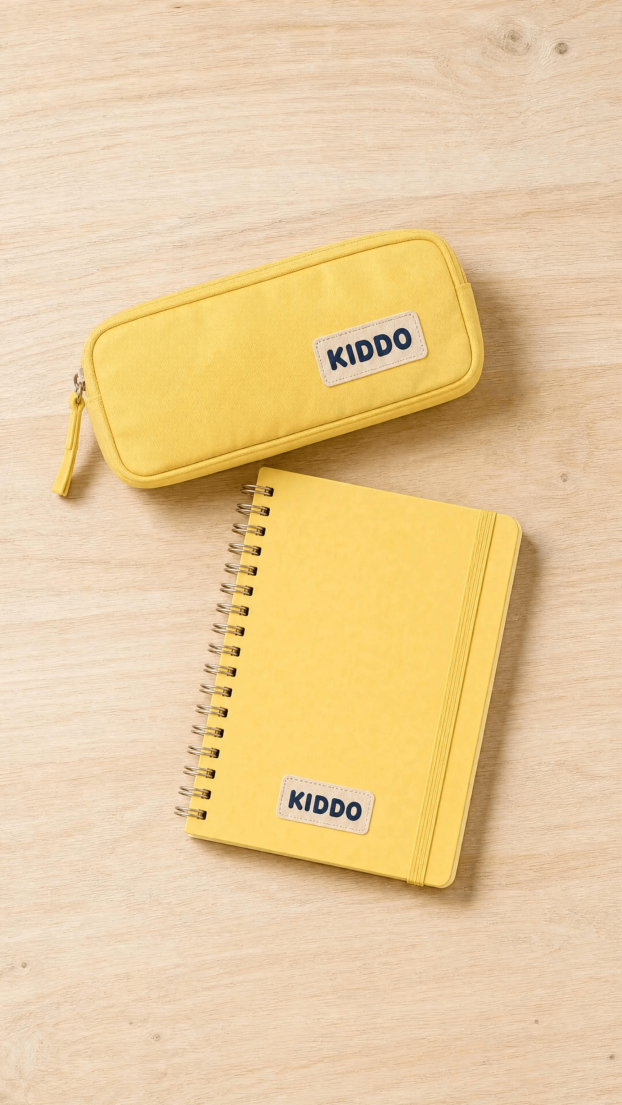 A butter-yellow pencil case and notebook in a clean overhead composition.