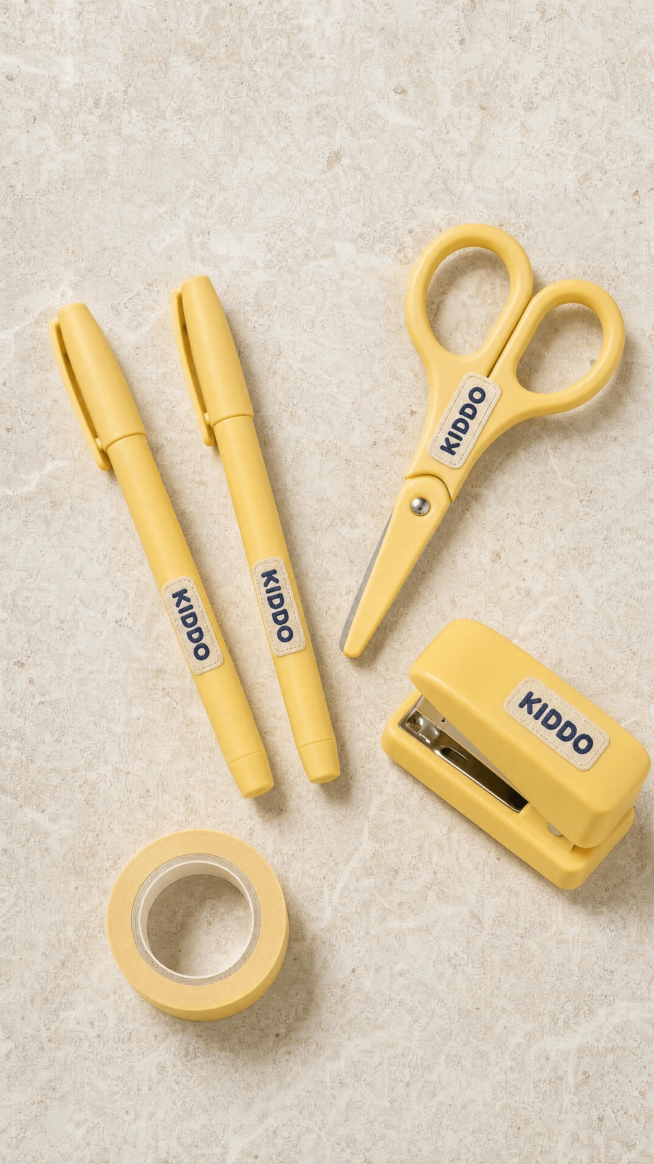 Butter-accented stationery radiates across a clean stone flatlay.