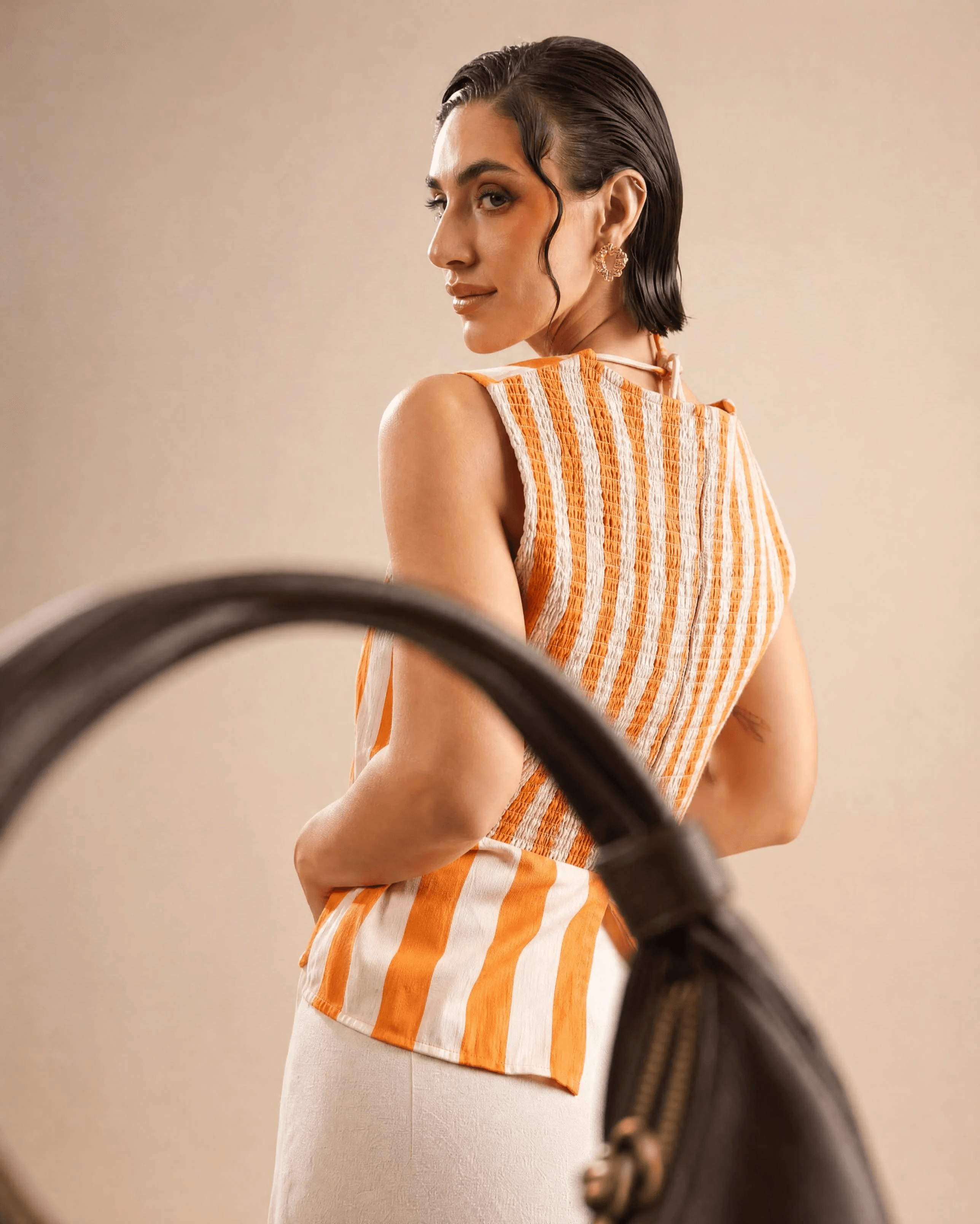 LUNARA: Looking Back — The strap crosses the frame as she looks back over her shoulder