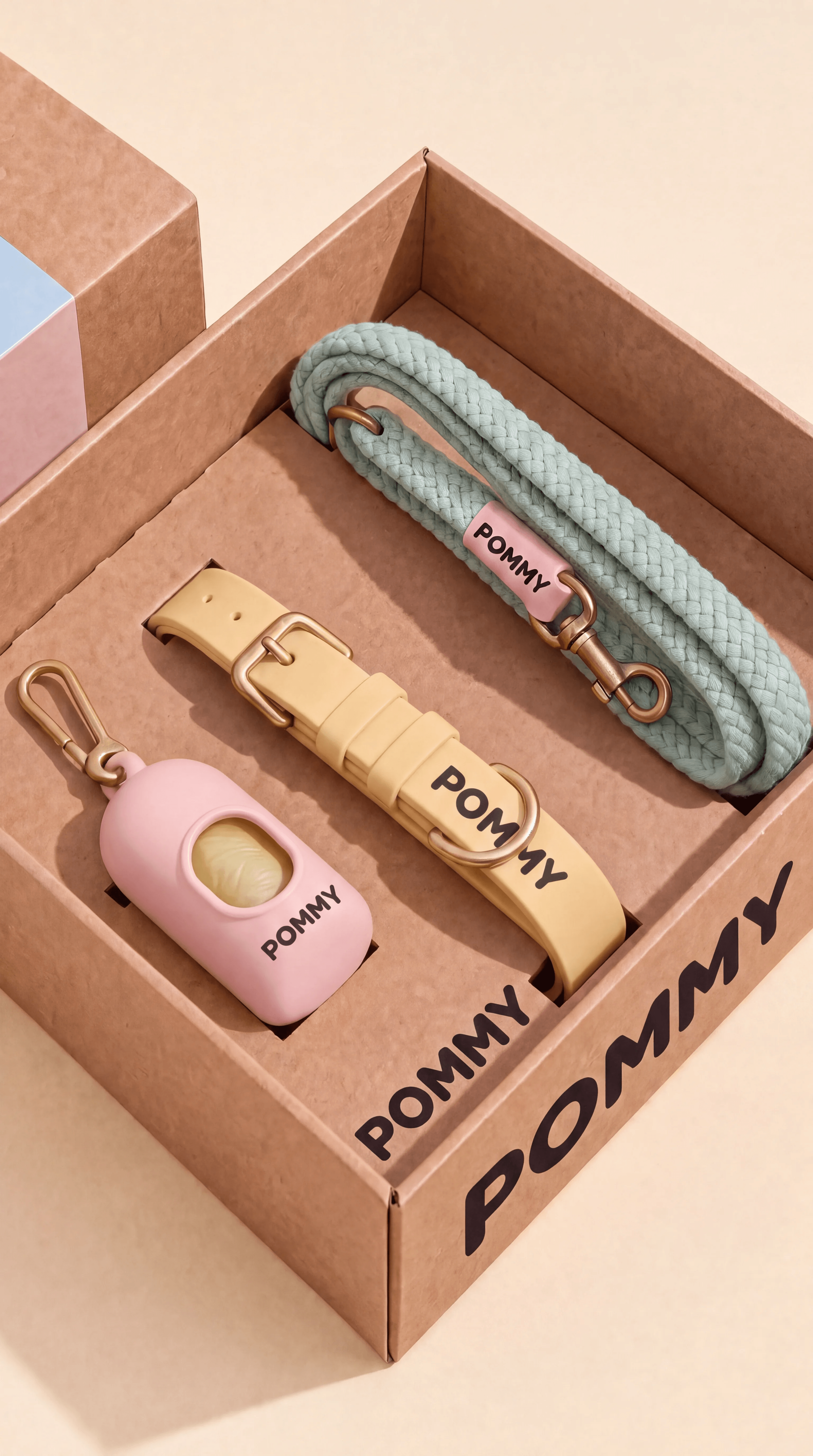 Open POMMY gift box containing a pastel rope leash, court collar, and dispenser, variation one