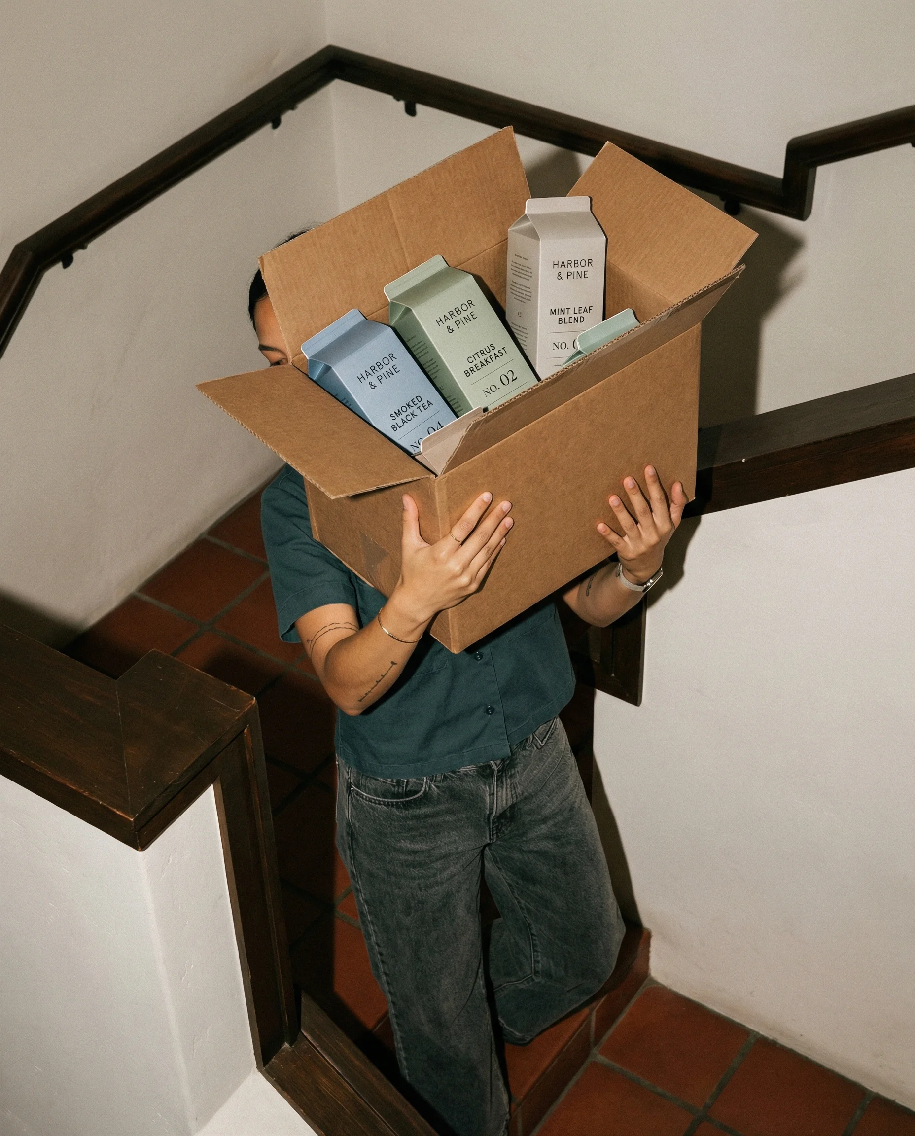 Tea Box Stair Carry scene example for Product Launch Ad Ideas for Ecommerce Campaigns