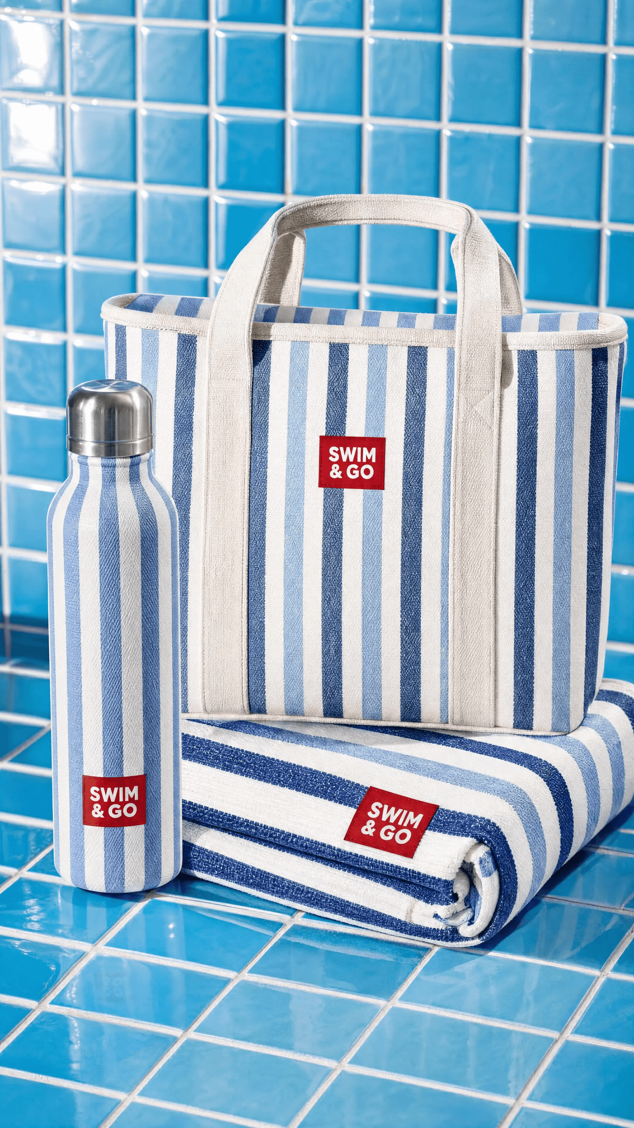 SWIM & GO tote, bottle, and folded towel against blue pool tiles