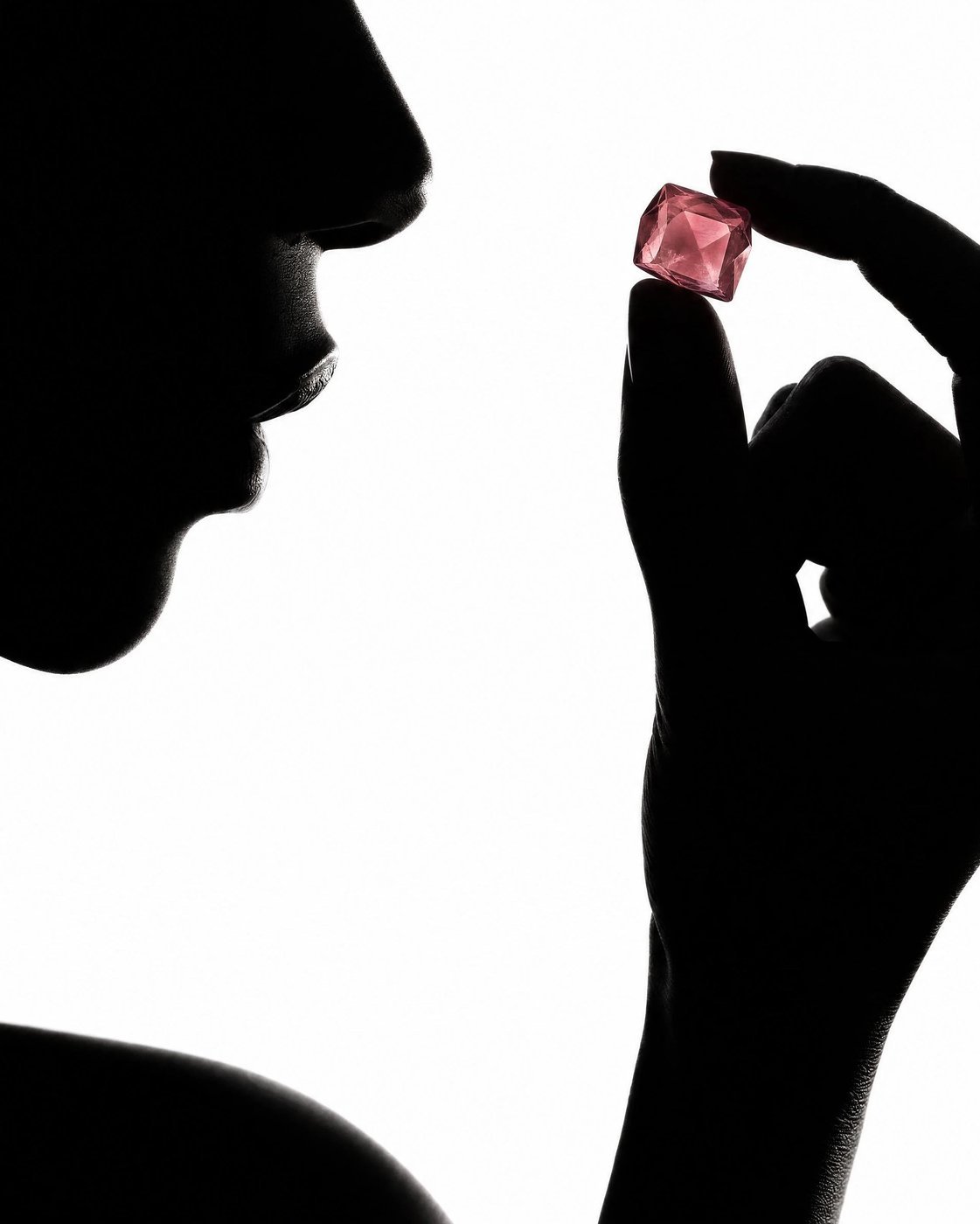 VITRIA: Silhouette & Stone — A single faceted gummy held in dramatic silhouette
