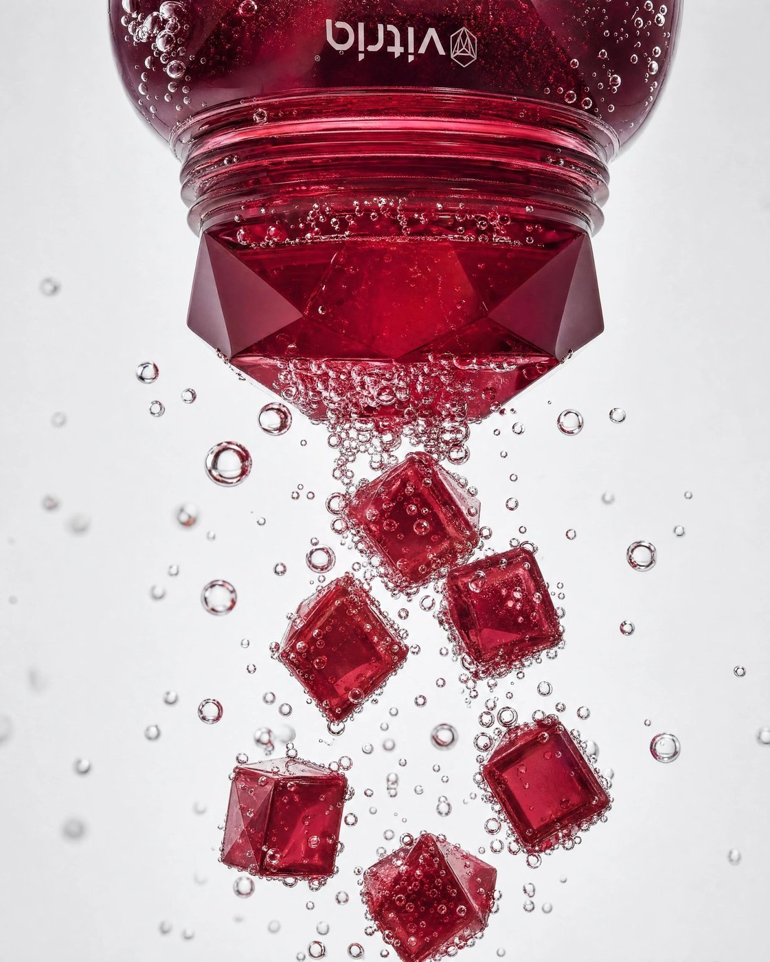 VITRIA: Poured, Not Measured — Gummies tumbling from an inverted bottle in a wash of bubbles